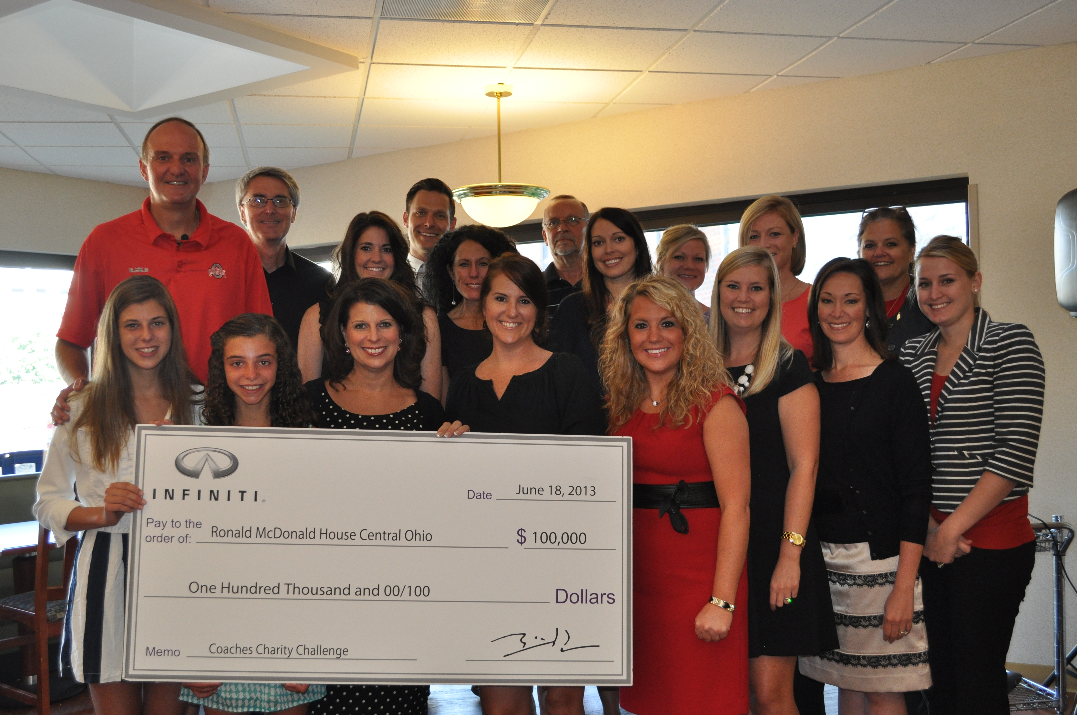 Coach Matta, Barb (3rd from left), and their daughters presenting RMHC with the 2013 Coaches' Charity Challenge check